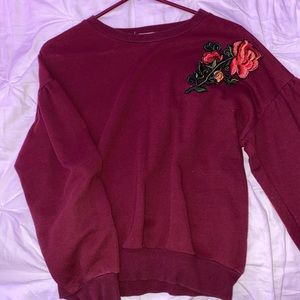red crewneck with rose